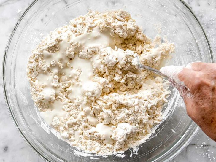 Flour and buttermilk in bowl for Buittermilk Biscuits foodiecrush.com