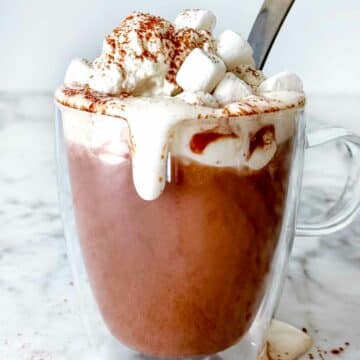 Hot Chocolate with whipped cream and marshmallows foodiecrush.com #recipe #hotchocolate