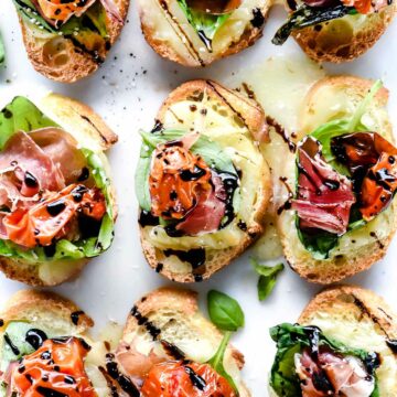 Melted Mozzarella Caprese Crostini Toasts | foodiecrush.com #appetizer #crostini #caprese #recipes