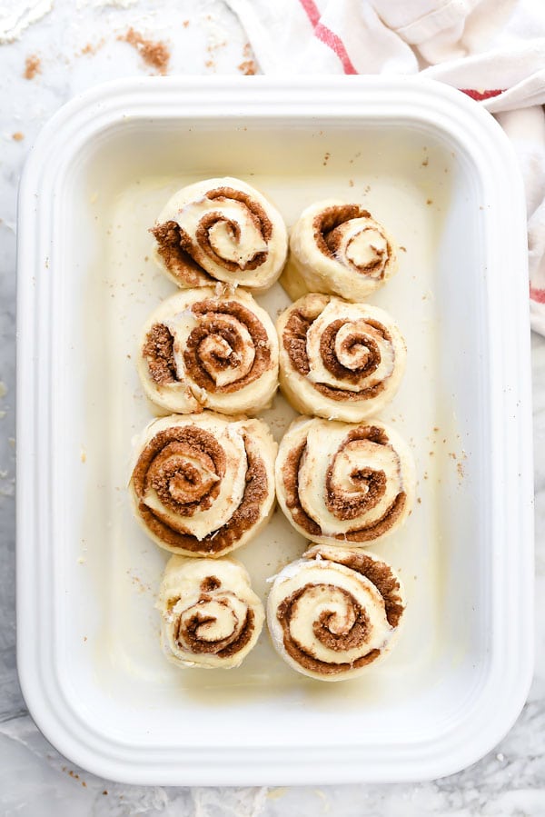 homemade cinnamon rolls in white baking dish 