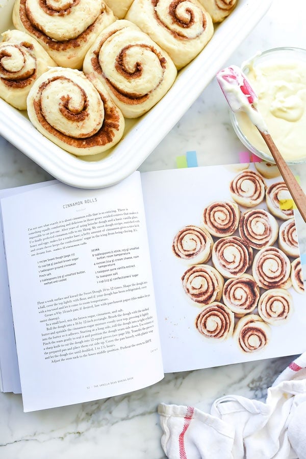 pan of easy cinnamon rolls next to cookbook