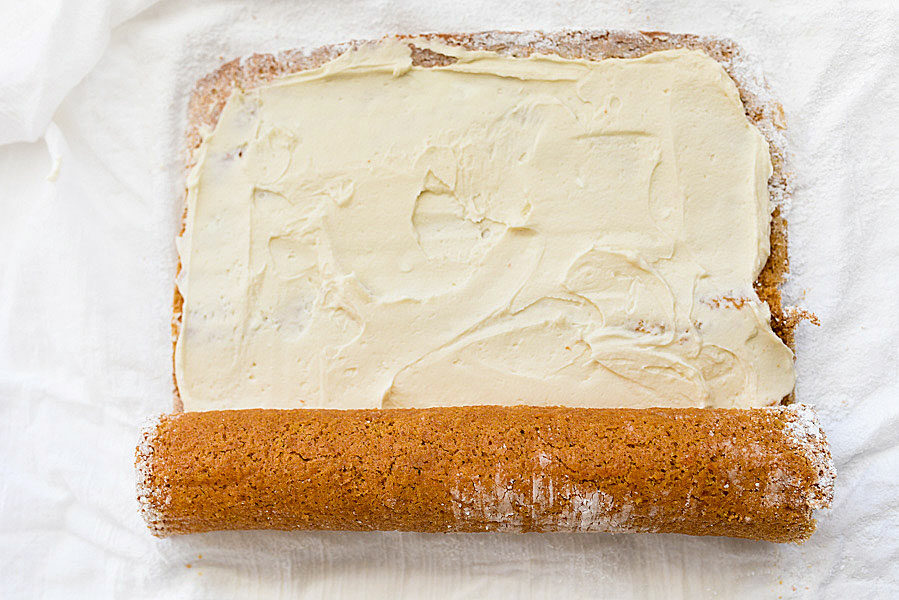 rolling up a pumpkin roll cake