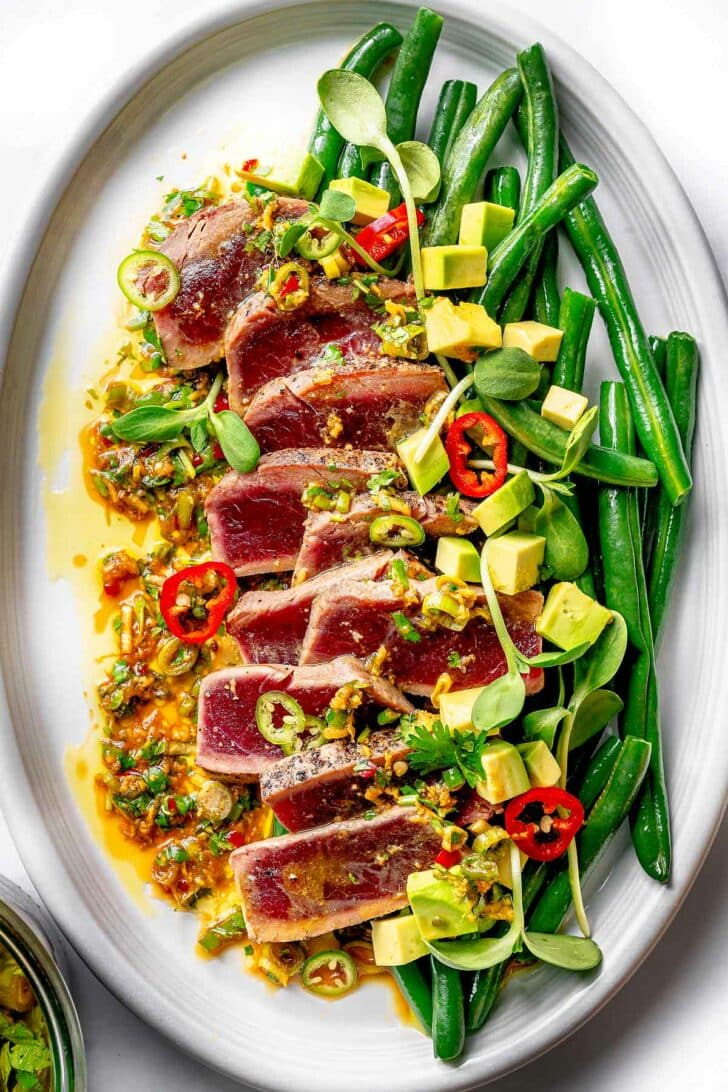 Seared Ahi Tuna on a platter with green beans foodiecrush.com