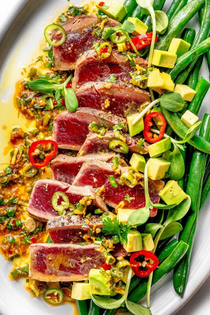 Seared Ahi Tuna on a platter with green beans foodiecrush.com